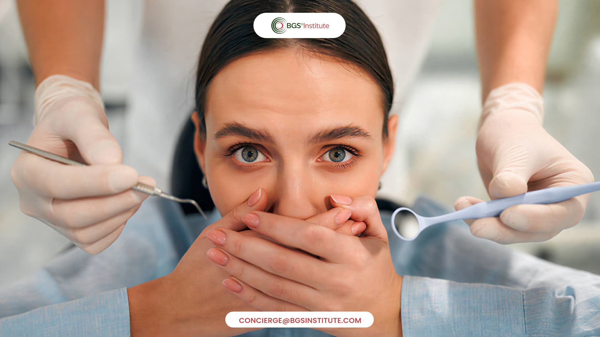 Anxious dental patient covering her mouth as a dentist prepares for an examination