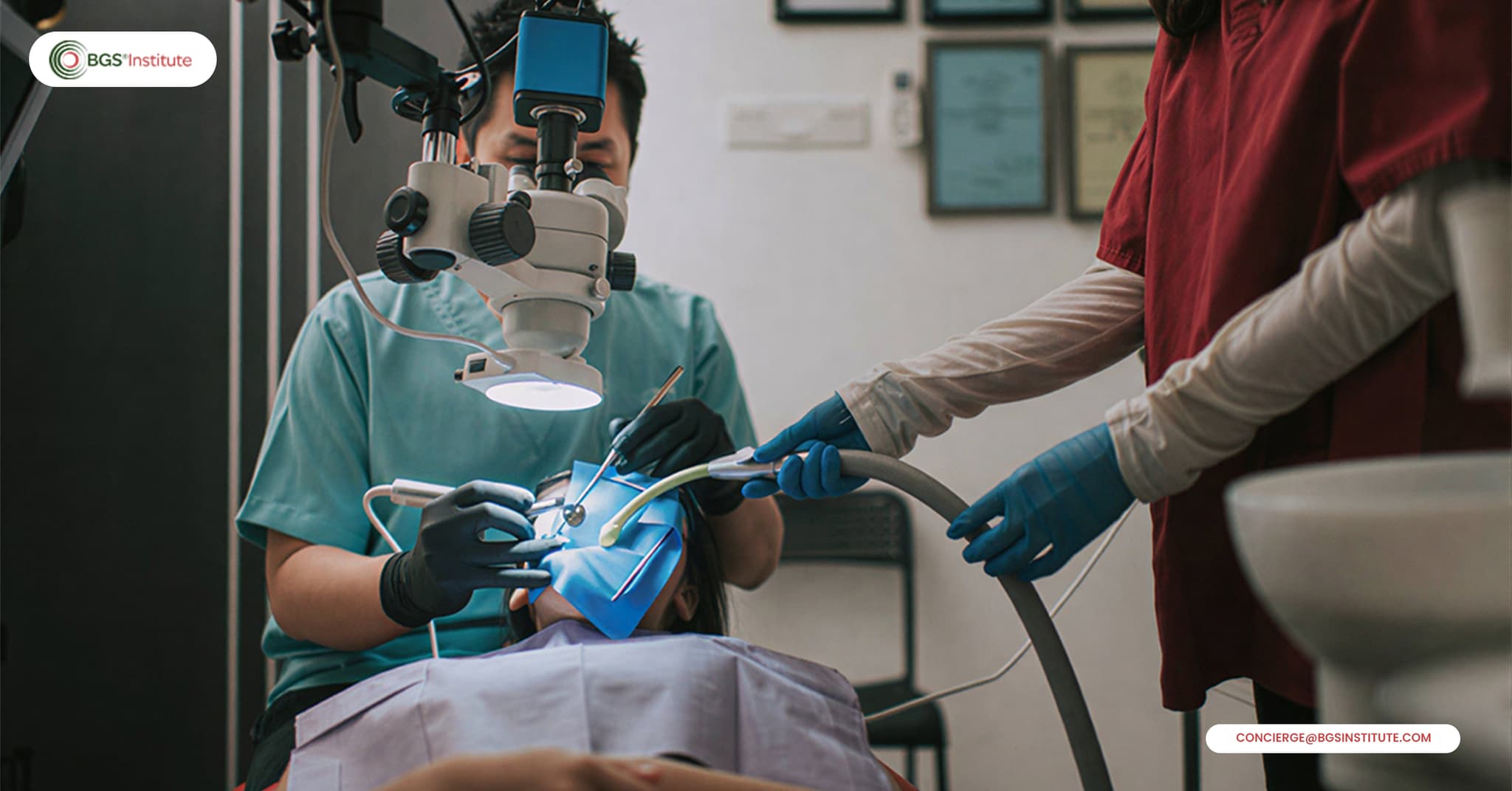 Dentist performing SMART amalgam removal with a dental microscope, suction, and protective barriers for safer biological dentistry care.