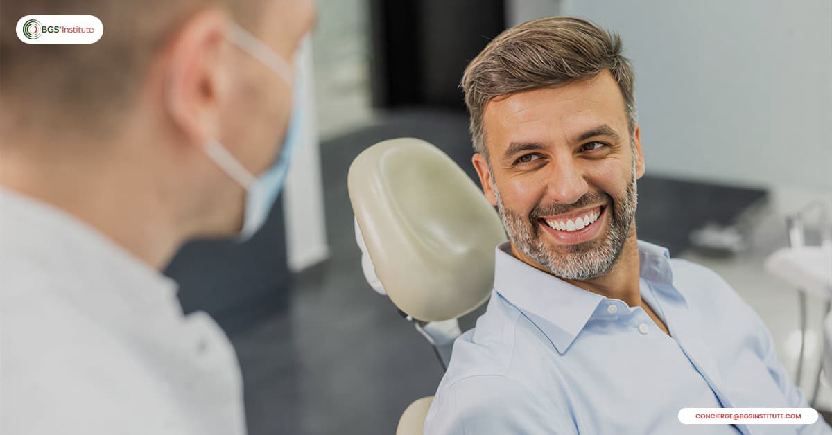 Patient smiling during a Biological Dentistry consultation focused on recovery and healing support